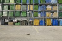 rows of green and yellow boxes stacked on top of each other in an open garage