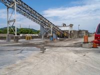 an industrial quarry with cement making equipment in it's pit area on a partly cloudy day