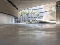 an empty parking garage is shown with a red skateboard in the foreground of it