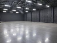 a hangar room with metal walls and lots of windows with recess lighting on the ceiling