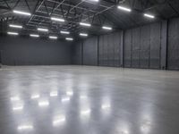 a hangar room with metal walls and lots of windows with recess lighting on the ceiling