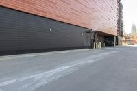 black building with a red roof with windows on both sides and yellow door frames in middle of driveway