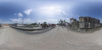 a blurry image of a road with a construction area in the background and a blue sky in the middle