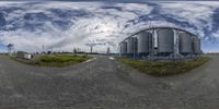 a fisheye shot taken in an industrial setting with a sky background that resembles circular