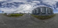 a fisheye shot taken in an industrial setting with a sky background that resembles circular