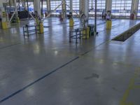 a large warehouse building with a metal and plastic flooring area and several workers working on equipment