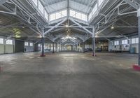 inside an empty industrial warehouse with no roof or columns, or pipes for the floors