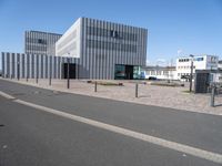 a paved parking area with several buildings in the background, and the road has been cleared to be used for traffic