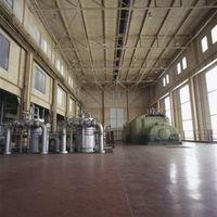 a large room with a lot of windows and different type of machines on the floor
