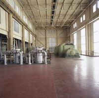 a large room with a lot of windows and different type of machines on the floor