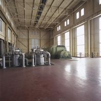 a large room with a lot of windows and different type of machines on the floor