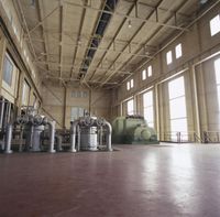 a large room with a lot of windows and different type of machines on the floor