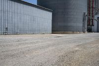 a view of an industrial warehouse with two tanks on a clear day with no clouds