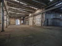 a dirty warehouse in an old warehouse with metal pipes, roof and concrete floors and ceilings