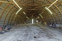 two large grain bins sit in the center of a field, surrounded by silos