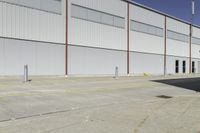 a street next to an industrial warehouse with a yellow line drawn in between the two buildings