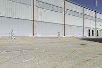 a street next to an industrial warehouse with a yellow line drawn in between the two buildings