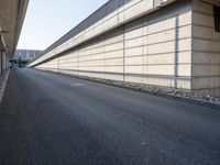 an empty street and an overpass under a bridge that runs through town, and across town