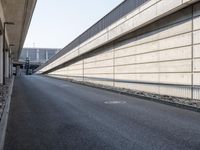 an empty street and an overpass under a bridge that runs through town, and across town