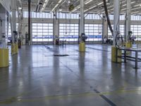 a warehouse filled with lots of empty machines and a blue chair in the middle of the room
