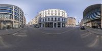 the view of an intersection from a fish eye lens as a car travels down a street