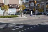 an intersection with street lights, stop lights and pedestrians at the corner of the intersection