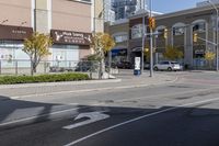 an intersection with street lights, stop lights and pedestrians at the corner of the intersection