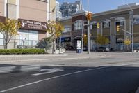 an intersection with street lights, stop lights and pedestrians at the corner of the intersection