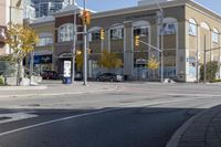 an intersection with street lights, stop lights and pedestrians at the corner of the intersection