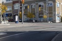 an intersection with street lights, stop lights and pedestrians at the corner of the intersection