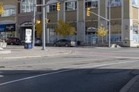 an intersection with street lights, stop lights and pedestrians at the corner of the intersection