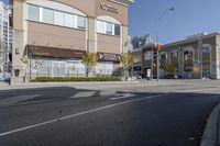 an intersection with street lights, stop lights and pedestrians at the corner of the intersection