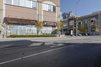 an intersection with street lights, stop lights and pedestrians at the corner of the intersection