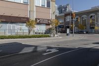 an intersection with street lights, stop lights and pedestrians at the corner of the intersection