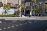 an intersection with street lights, stop lights and pedestrians at the corner of the intersection