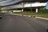 the building is made of concrete and has arched windows on either side of it and on top of its two floors