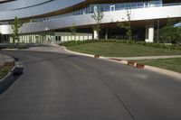 the building is made of concrete and has arched windows on either side of it and on top of its two floors