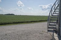 a truck is parked next to some grass and steps on the side of the road