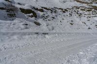 an image of a person skis down the slope in the snow to the right side