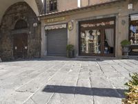 a large building with a cross in front of it on the street in italy, a sun shines through the window