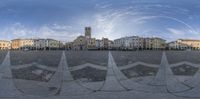 many buildings are seen through a fish eye lens as part of a street scene in italy