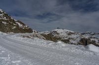 a person standing at the top of a snowy mountain with skis on their feet