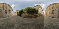 a 3d image of an intersection with trees growing out of rocks near buildings and a paved walkway between two streets