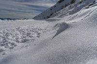 a large amount of snow is visible on the mountain slope, which is covered in thin, white powder