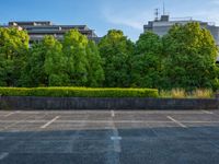 two empty parking spaces with two empty doors and a large window on the wall between two buildings