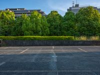 two empty parking spaces with two empty doors and a large window on the wall between two buildings