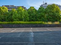 two empty parking spaces with two empty doors and a large window on the wall between two buildings