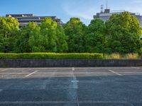 two empty parking spaces with two empty doors and a large window on the wall between two buildings