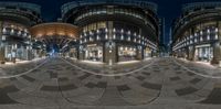 two spherically designed building sit in front of each other at night with lights shining on