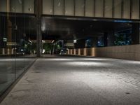 an open door at the lobby of a modern building with glass doors on either side